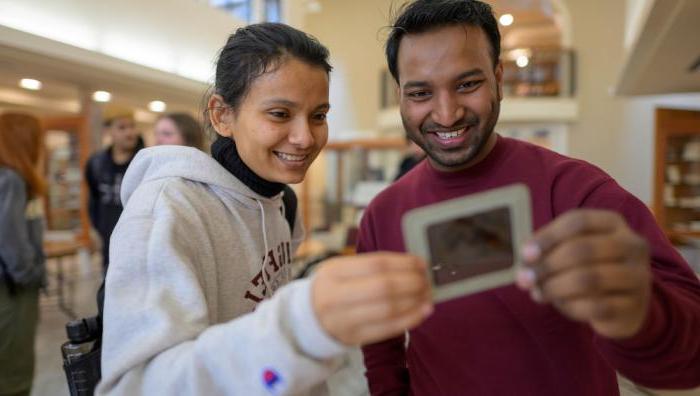 2 international students looking at piece of history in the Museum